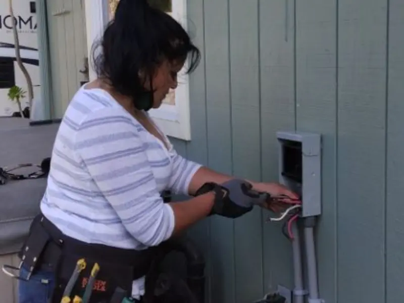 Licensed electrician wiring an exterior subpanel in Frederickson